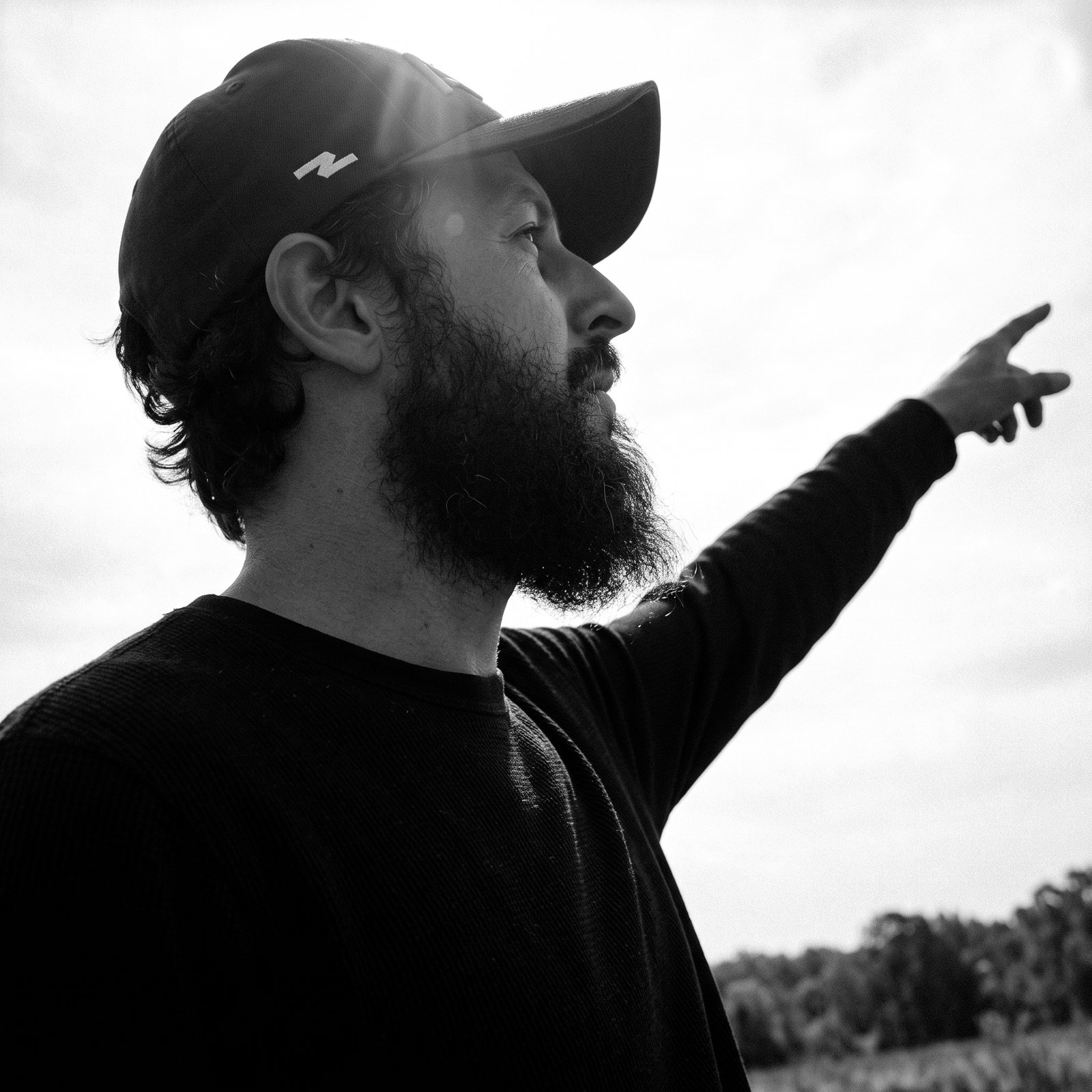Fabio Prudencio pointing across a field